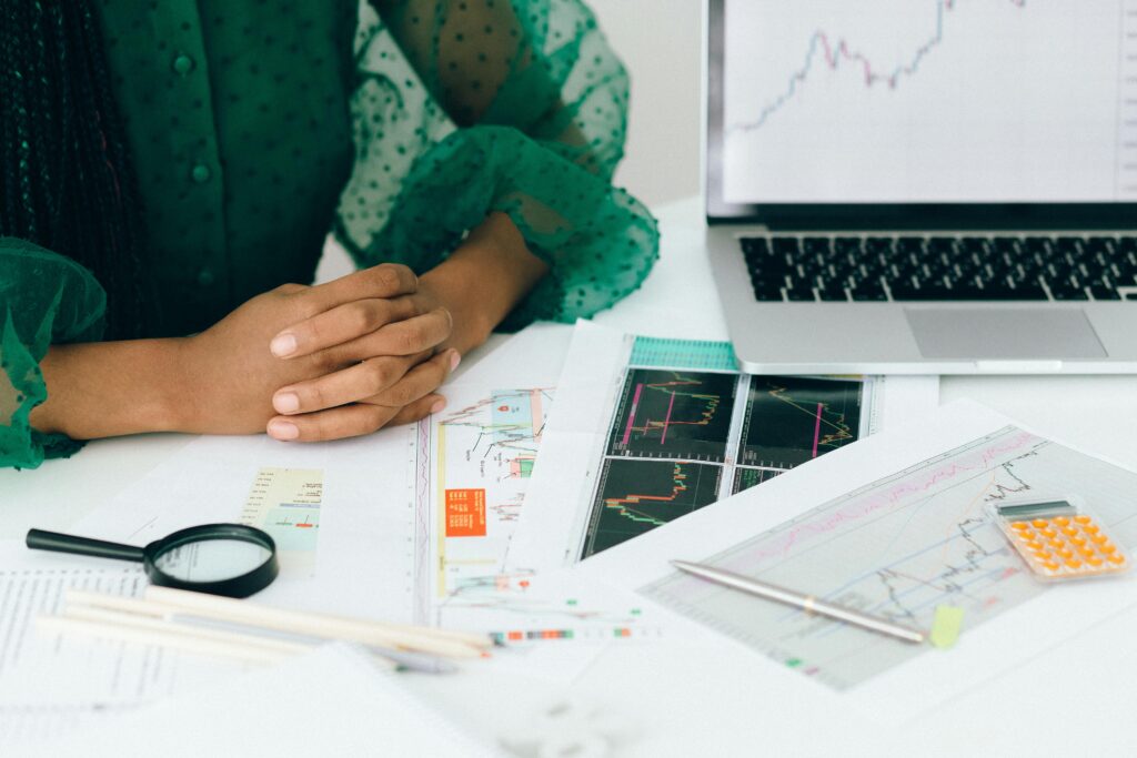 a woman frustrated and looking at her expense management documents in distress because she is doing them manually. only her hands are visible in the picture.